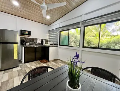 a kitchen and dining room with a table and chairs at `Luci's Home' in Uvita