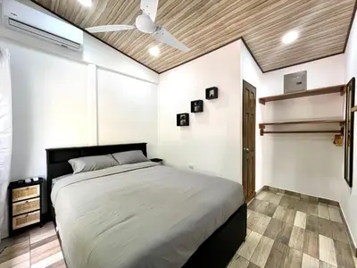 a bedroom with a bed and a ceiling fan at `Luci's Home' in Uvita