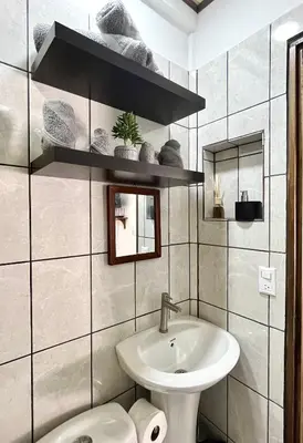 a bathroom with a sink and a toilet at `Luci's Home' in Uvita