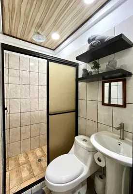 a bathroom with a toilet and a sink at `Luci's Home' in Uvita