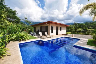 a swimming pool in front of a villa at Villa Romancing The Stone in Ojochal