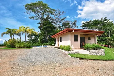 a small house with a gravel driveway at Villa Romancing The Stone in Ojochal