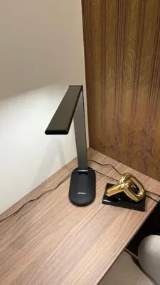 a black object sitting on top of a wooden desk at Luxury apartment 10 min to Airport Be Cariari Condo #402 in La Asunción