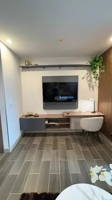 a living room with a flat screen tv on a wall at Luxury apartment 10 min to Airport Be Cariari Condo #402 in La Asunción