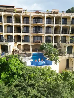 an external view of a hotel with a swimming pool at Majestic Oceanview Condo with King Beds in Coco