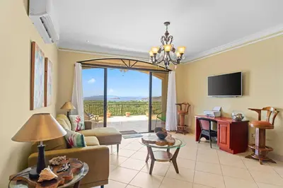 a living room with a couch and a table at Majestic Oceanview Condo with King Beds in Coco