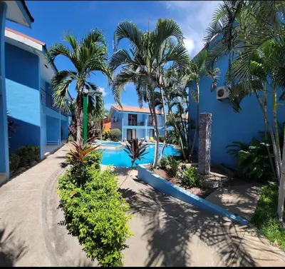 a resort with a swimming pool and palm trees at Renovated apartment in Las Palmas in Coco