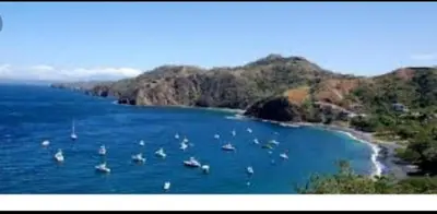 a group of boats in the water near a beach at Renovated apartment in Las Palmas in Coco