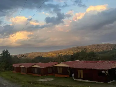 a row of cottages on a hill with a sky at Cabañas venado in Venado