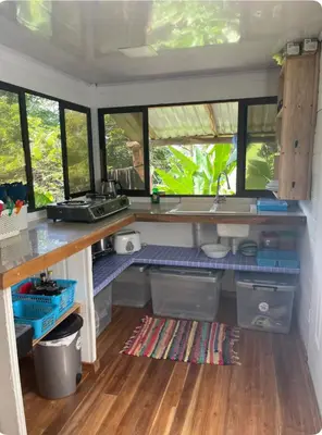 a kitchen with a counter and some windows at Beachfront sunset Bungalow in Boca de Ario