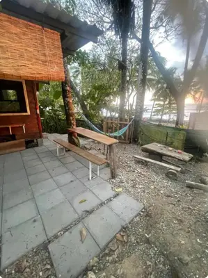 a park with a bench and a house at Beachfront sunset Bungalow in Boca de Ario