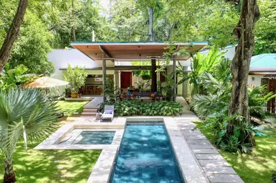 a swimming pool in the backyard of a house at CasaMAR Santa Teresa on the Beach in Carmen