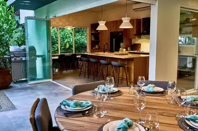 a dining room with a table with wine glasses at CasaMAR Santa Teresa on the Beach in Carmen