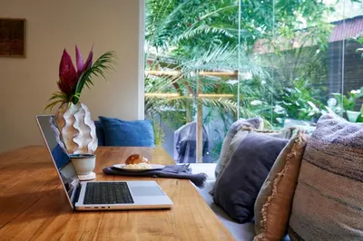 a laptop sitting on a wooden table in a living room at CasaMAR Santa Teresa on the Beach in Carmen