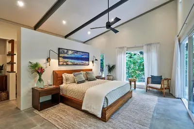 a bedroom with a bed and a ceiling fan at CasaMAR Santa Teresa on the Beach in Carmen