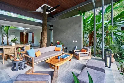 an outdoor living room with a couch and a table at CasaMAR Santa Teresa on the Beach in Carmen