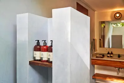 a shelf with wine bottles on it in a bathroom at CasaMAR Santa Teresa on the Beach in Carmen