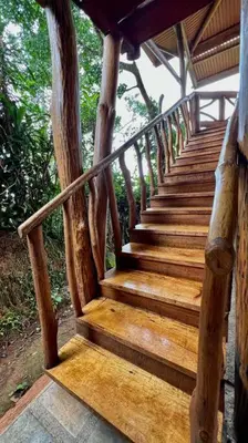 a set of wooden stairs in a building at Cabaña Vistas Paraíso in Turrialba