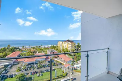 an apartment balcony with a view of the ocean at Ocean View Condo at Viva Jaco, Newly Built in Jacó