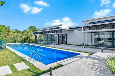 an exterior view of a house with a swimming pool at Ocean View Condo at Viva Jaco, Newly Built in Jacó
