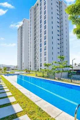 an empty swimming pool in front of a large building at Ocean View Condo at Viva Jaco, Newly Built in Jacó