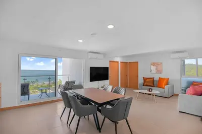 a living room with a table and chairs at Ocean View Condo at Viva Jaco, Newly Built in Jacó