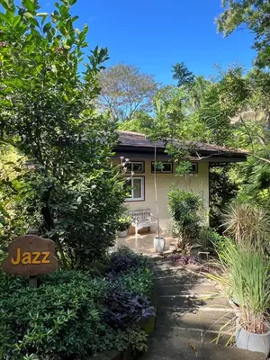 a house with a garden in front of it at Jazz Studio in Nosara