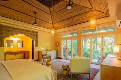 a large room with a bed and a kitchen with windows at Jazz Studio in Nosara