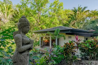 a statue of a woman in front of a house at Jazz Studio in Nosara