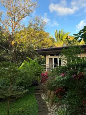 a small house with a garden in front of it at Jazz Studio in Nosara