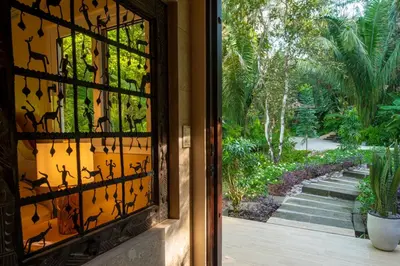 a glass door with a view of a garden at Jazz Studio in Nosara