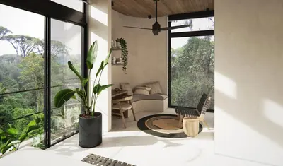 a living room with a couch and a chair and windows at Soleil Samara in Sámara