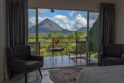 a bedroom with a view of a mountain at Hilltop Bungalow #1 W Spectacular Volcano View in El Fosforo