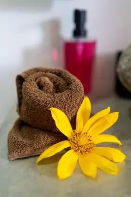 a yellow flower sitting next to a towel at Hilltop Bungalow #1 W Spectacular Volcano View in El Fosforo