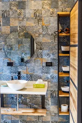 a bathroom with a sink and a tile wall at Narime Costa Rica in Palmira