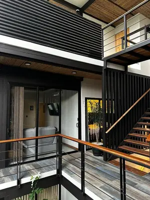 a modern house with a balcony with a staircase at Narime Costa Rica in Palmira
