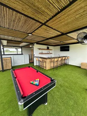a ping pong table in a room with a bar at Narime Costa Rica in Palmira