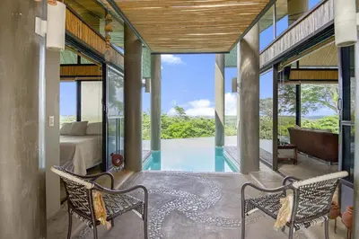 a house with a pool and a bedroom at Villa La Loma, Oceanview, Private Pool and AC! in Tarcoles