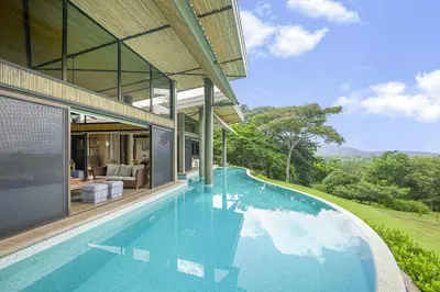 a house with a swimming pool in front of it at Villa La Loma, Oceanview, Private Pool and AC! in Tarcoles