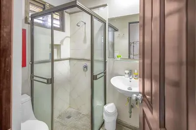 a bathroom with a shower and a toilet and a sink at Villa La Loma, Oceanview, Private Pool and AC! in Tarcoles