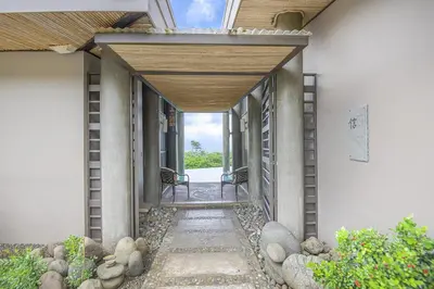 a hallway of a house with two chairs in it at Villa La Loma, Oceanview, Private Pool and AC! in Tarcoles