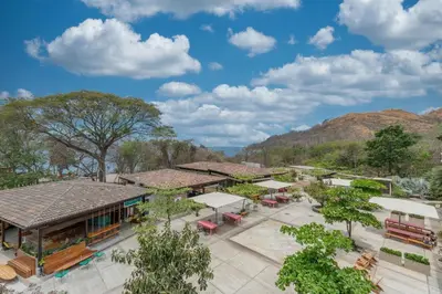 an overhead view of a resort with mountains in the background at Mercado 26- Ocean View Condo At Las Catalinas in Playa Danta
