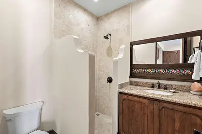 a bathroom with a toilet and a sink and a mirror at Beautiful Villa Walk to Beach in Playa Danta