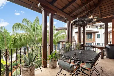 a patio with a table and chairs on a balcony at Beautiful Villa Walk to Beach in Playa Danta