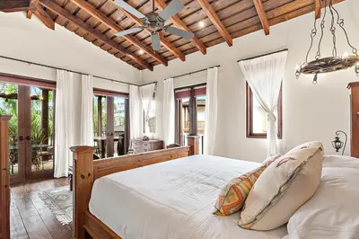 a bedroom with a bed with a wooden ceiling at Beautiful Villa Walk to Beach in Playa Danta
