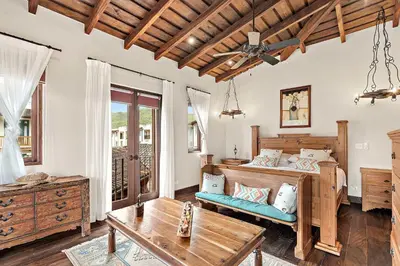 a bedroom with a bed and a table at Beautiful Villa Walk to Beach in Playa Danta