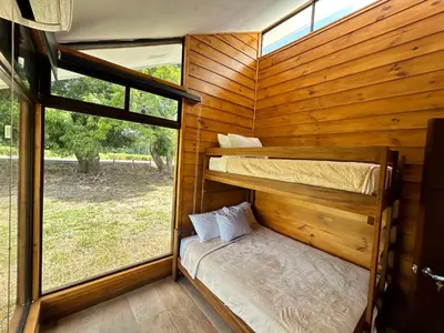 a room with two bunk beds and a window at Eco Casa Mango Lepanto #9 in Lepanto