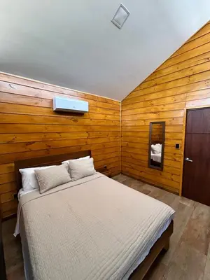 a bedroom with a bed in a wooden wall at Eco Casa Mango Lepanto #9 in Lepanto