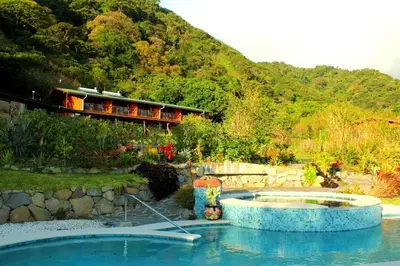 a swimming pool in a yard with a house at Camino Nuevo Monteverde Ecolodge in Monteverde Costa Rica