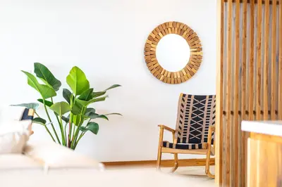a room with a mirror and a chair and a plant at Villa del Cielo - by Pura Villas in Uvita